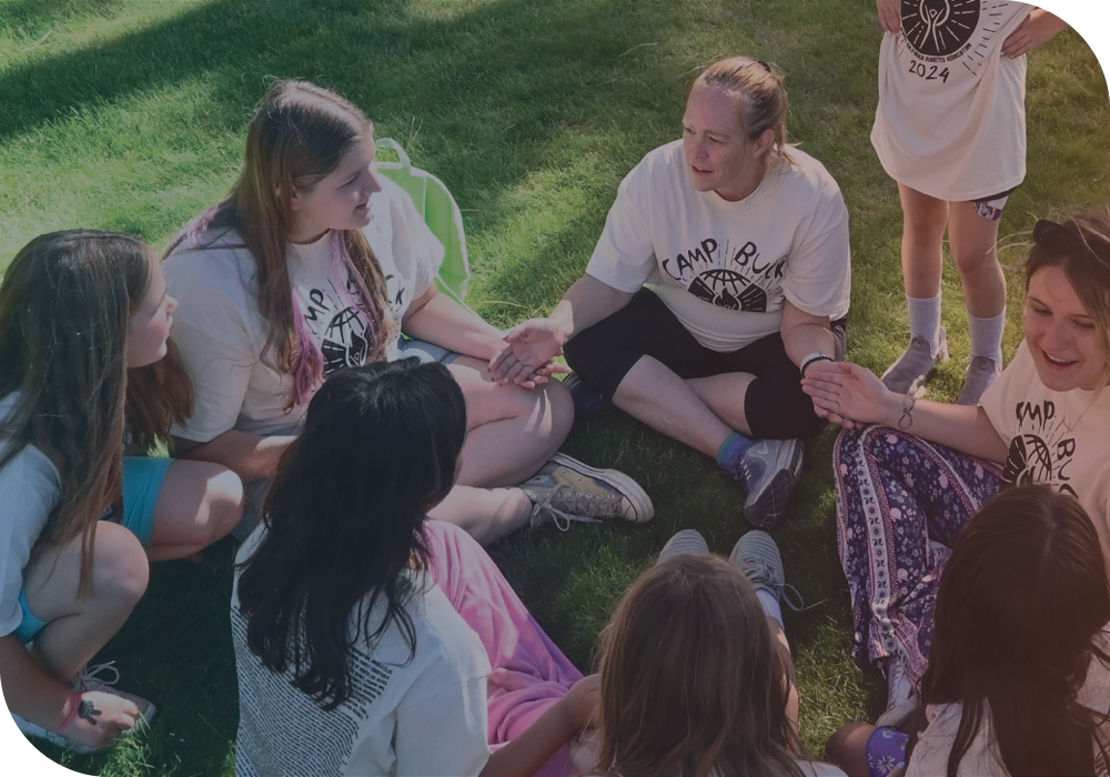 A group of participants of Camp Buck sitting in a circle together.